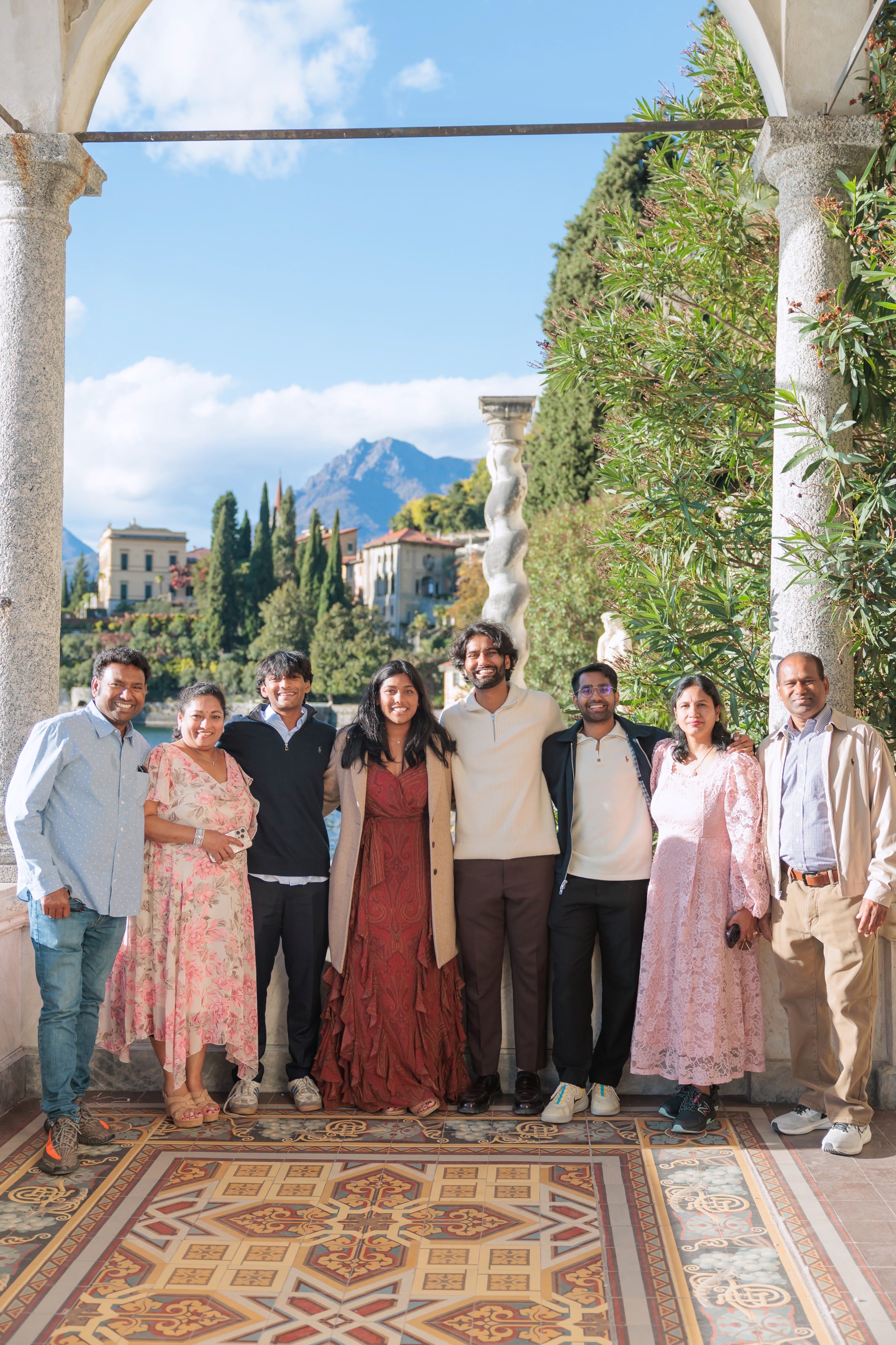 Esha and Anish celebrating their proposal with their families at Lake Como